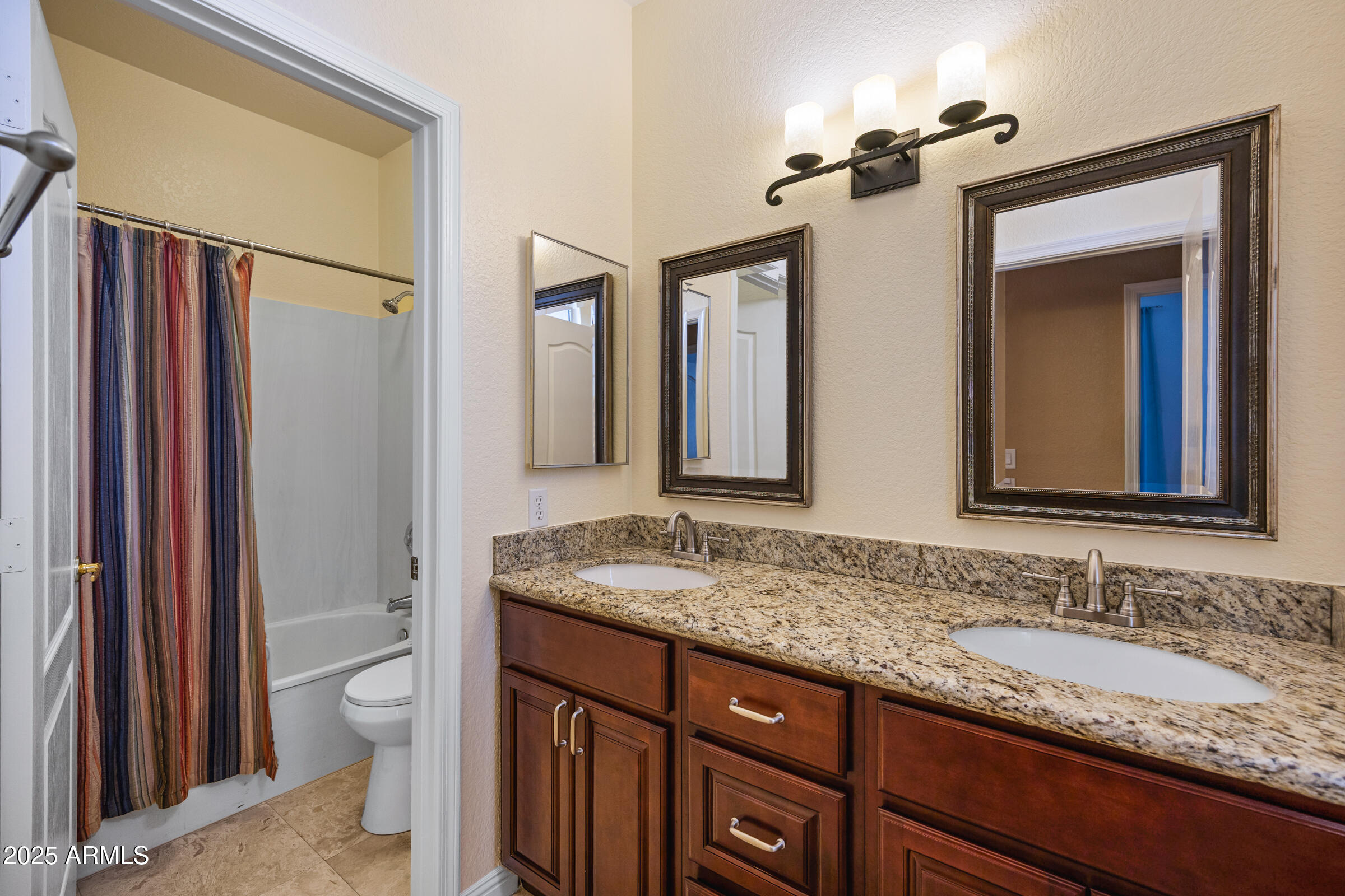 269 West El Freda Road Tempe, AZ 85284 - Photo 25 of 54 a bathroom with a granite countertop sink and a mirror