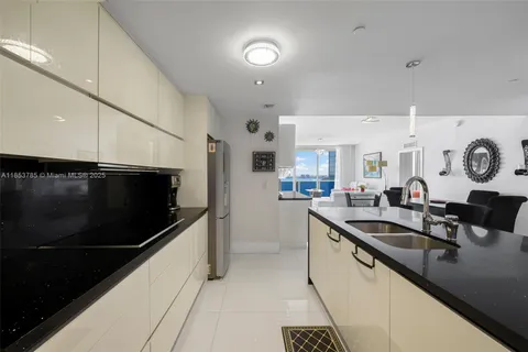 a kitchen with stainless steel appliances a refrigerator and a stove top oven