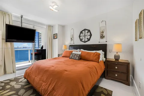 a bathroom with double vanity sink a mirror and a bathtub