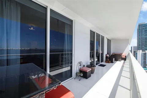 a kitchen with stainless steel appliances kitchen island granite countertop a dining table chairs and sink