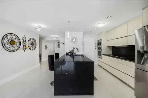 a kitchen with stainless steel appliances a stove a microwave and cabinets