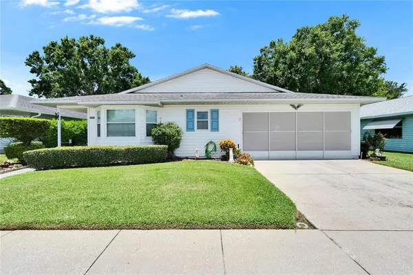 a view of a yard in front view of a house