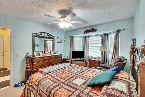 a kitchen with stainless steel appliances kitchen island granite countertop a sink dishwasher a stove a dining table and chairs with wooden floor