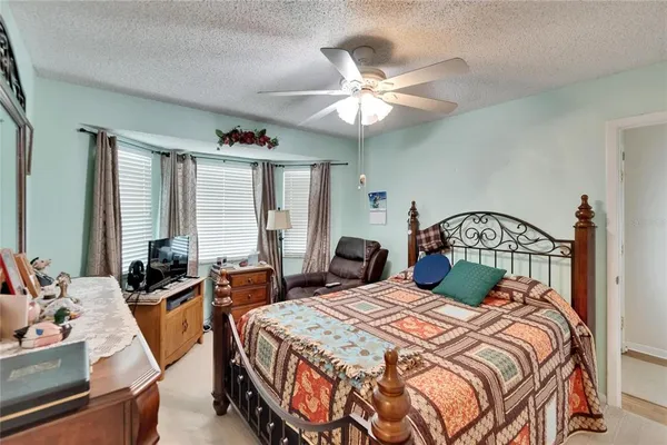 a kitchen with a sink dishwasher and white cabinets with wooden floor