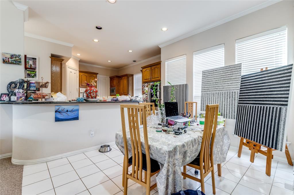 5929 Pebblestone Lane Plano, TX 75093 - Photo 13 of 24 a dining room with furniture and a kitchen view
