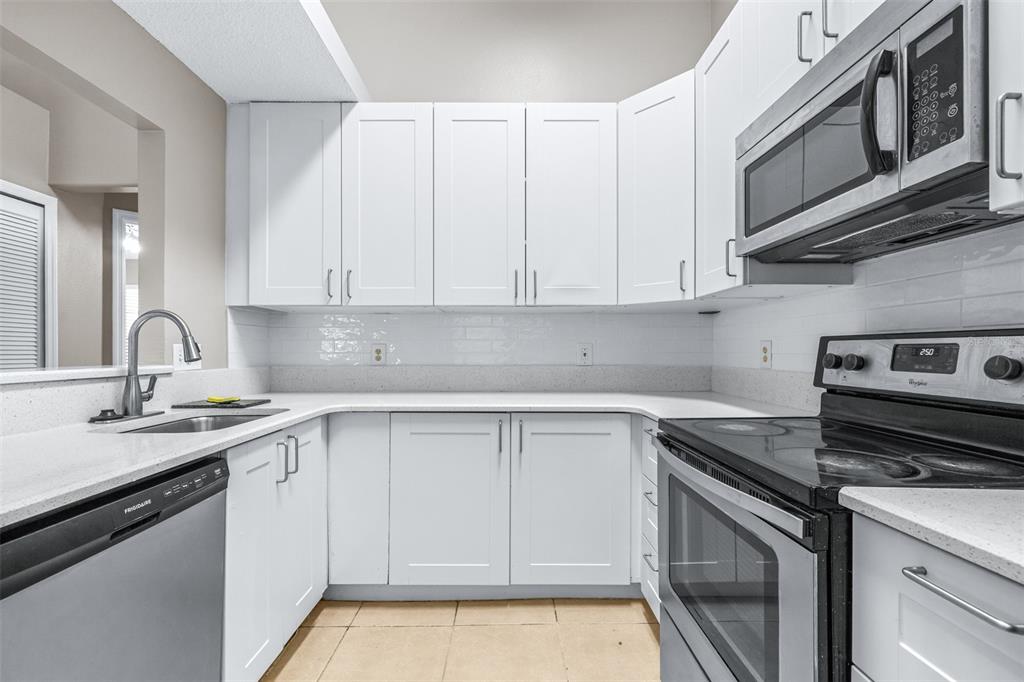 5100 Burchette Road, Unit 2505 Tampa, FL 33647 - Photo 14 of 47 a kitchen with stainless steel appliances granite countertop a sink stove and cabinets