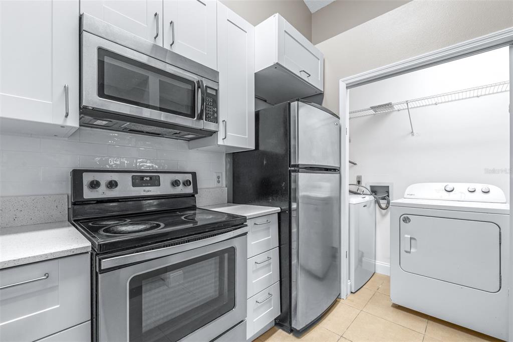 5100 Burchette Road, Unit 2505 Tampa, FL 33647 - Photo 16 of 47 a kitchen with a stove microwave and refrigerator