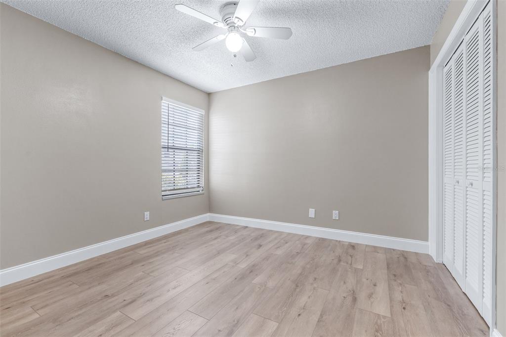 5100 Burchette Road, Unit 2505 Tampa, FL 33647 - Photo 24 of 47 a view of an empty room with wooden floor and a window