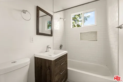 a bathroom with a sink a toilet and a bathtub