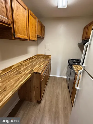 a view of storage and utility room with wooden floor