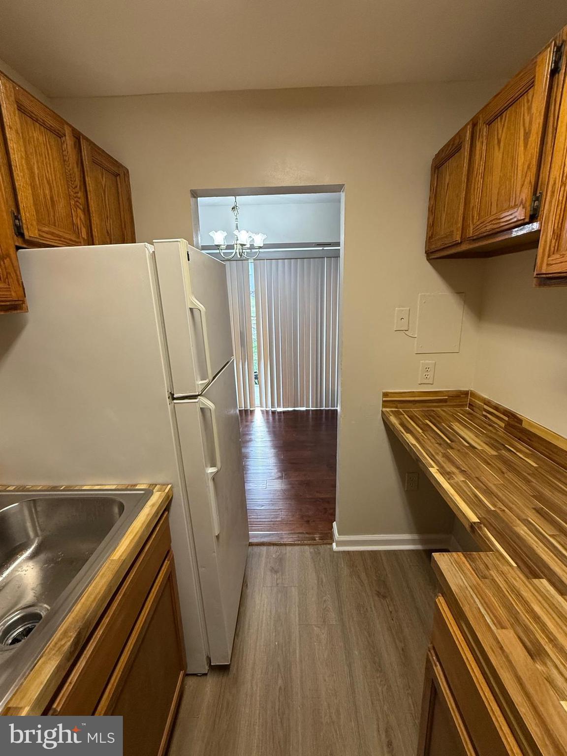 1604 Renate Drive, Unit 104 Woodbridge, VA 22192 - Photo 13 of 29 a view of a kitchen with wooden floor and electronic appliances