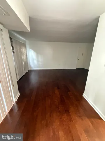 an empty room with wooden floor