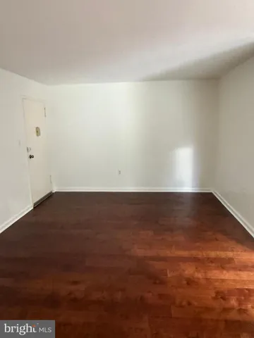 an empty room with wooden floor