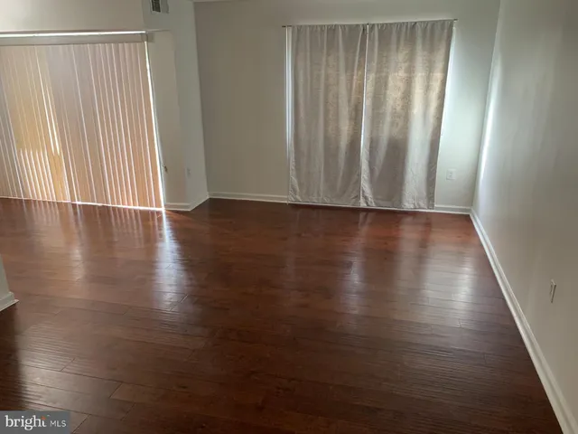 a view of wooden floor and windows in a room