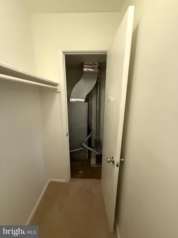 a view of hallway with stairs and a closet