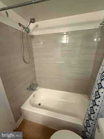 a bathroom with a bathtub and shower