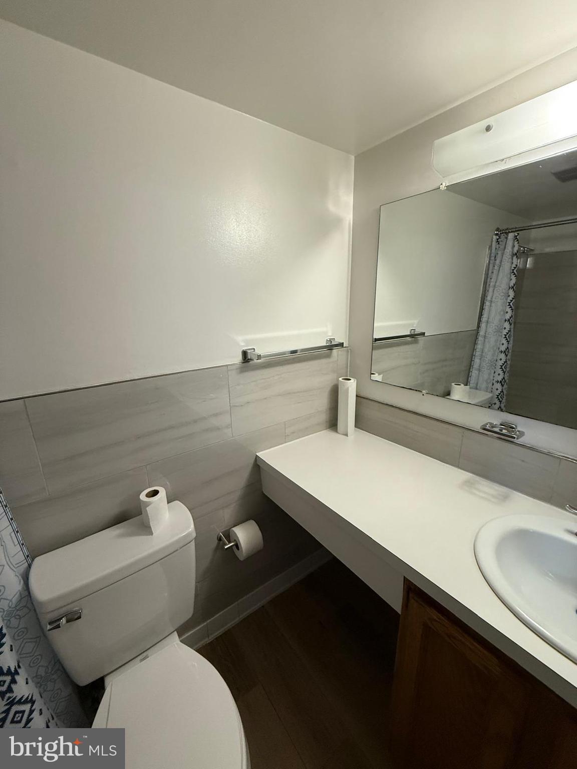 1604 Renate Drive, Unit 104 Woodbridge, VA 22192 - Photo 5 of 29 a bathroom with a sink a toilet and a mirror