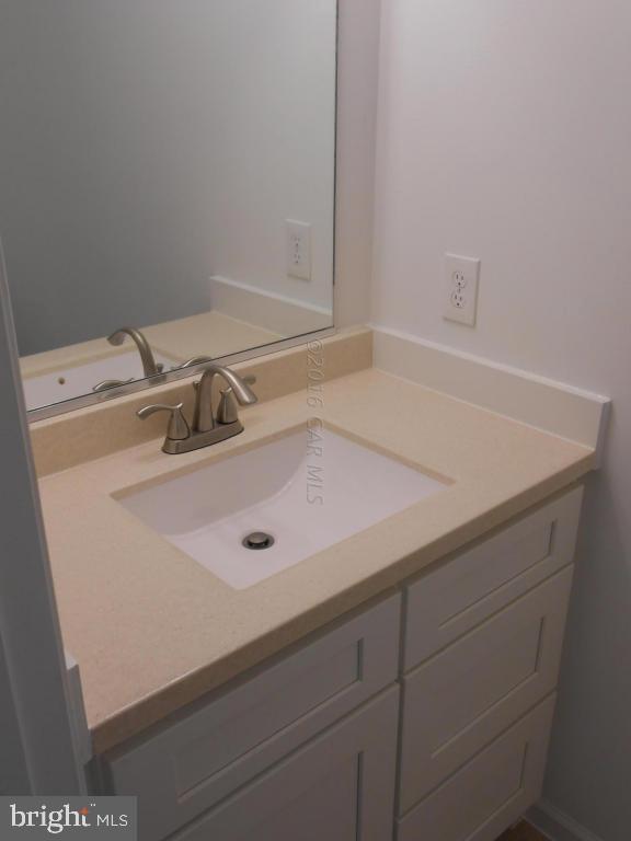 91 Windjammer Road Ocean Pines, MD 21811 - Photo 22 of 25 a bathroom with a sink and cabinets