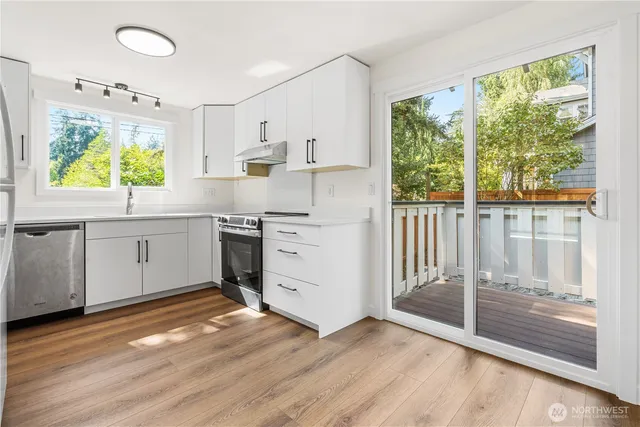 a kitchen with stainless steel appliances a stove top oven