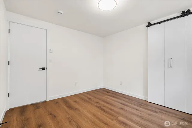 a view of a room with wooden floor