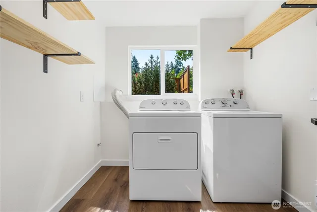 a utility room with sink dryer and washer