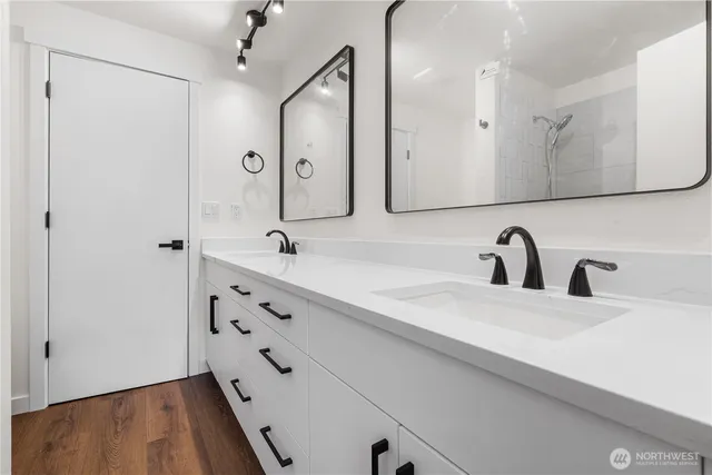 a bathroom with a double vanity sink mirror and double