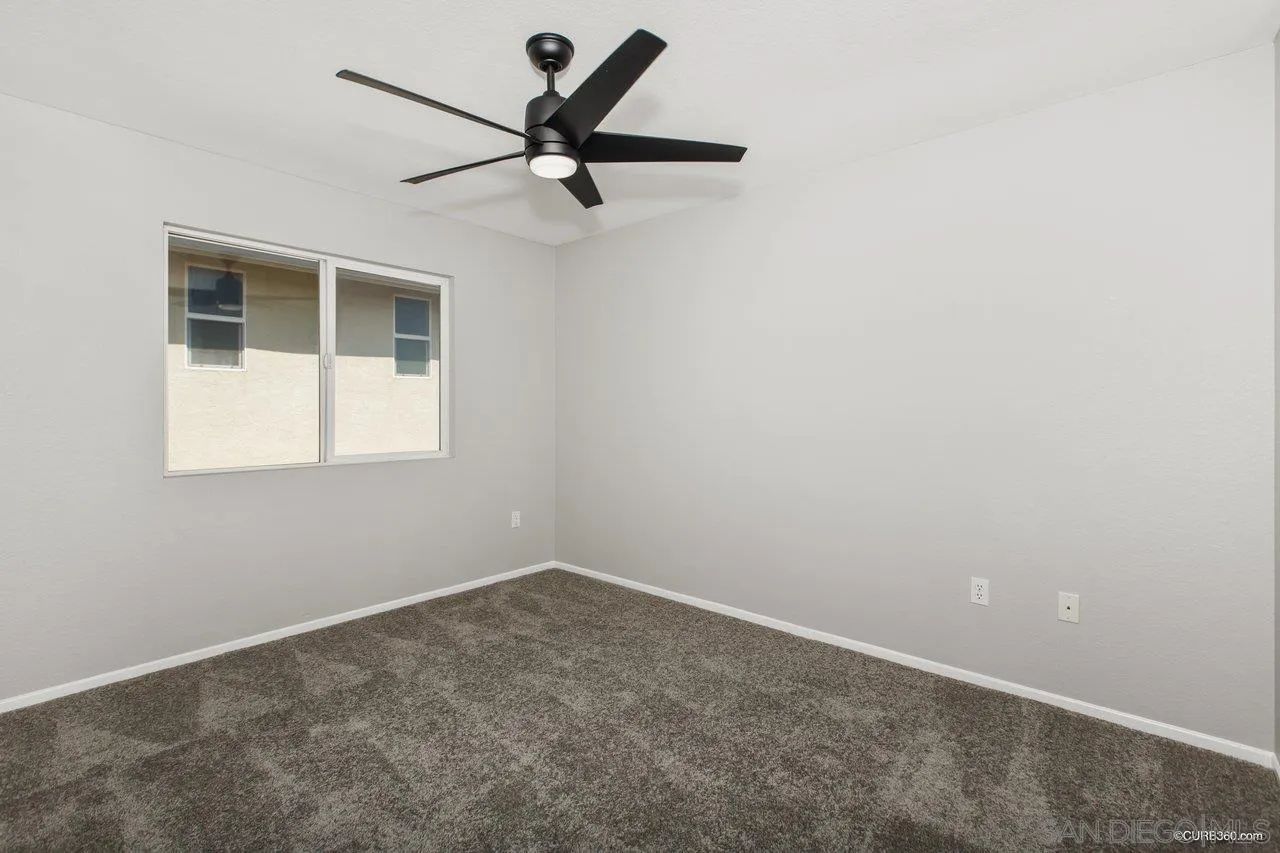 1867 McDougal Terrace El Cajon, CA 92021 - Photo 15 of 28 an empty room with a window and a fan