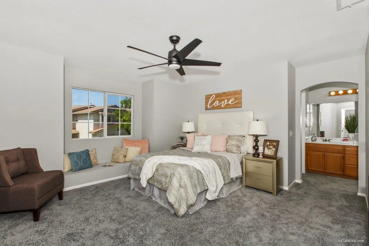 1867 McDougal Terrace El Cajon, CA 92021 - Photo 17 of 28 a bedroom with a bed and a couch