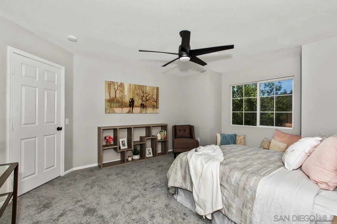 1867 McDougal Terrace El Cajon, CA 92021 - Photo 18 of 28 a bedroom with a bed and a window