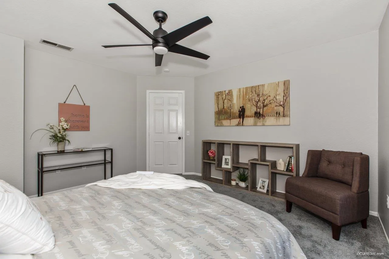 1867 McDougal Terrace El Cajon, CA 92021 - Photo 19 of 28 a bedroom with a bed couch and window