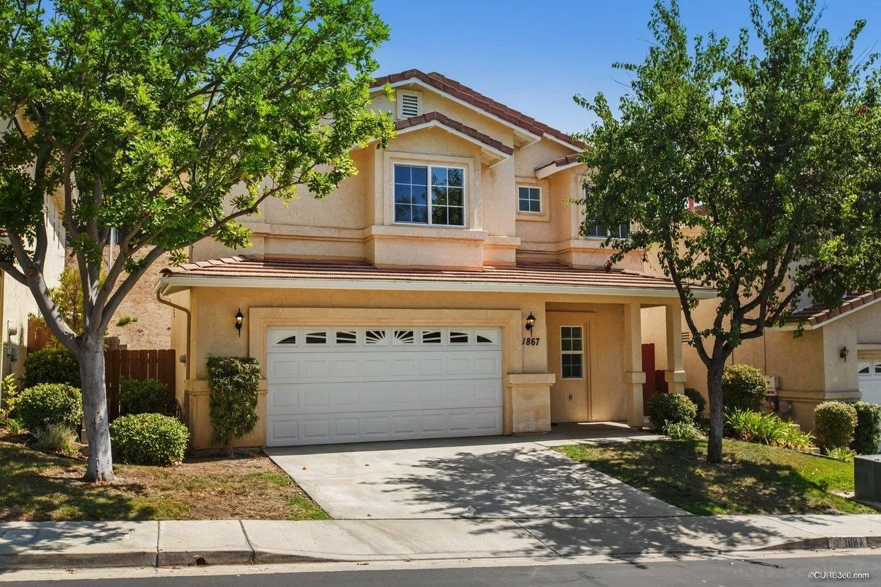 1867 McDougal Terrace El Cajon, CA 92021 - Photo 2 of 28 a front view of a house with a yard