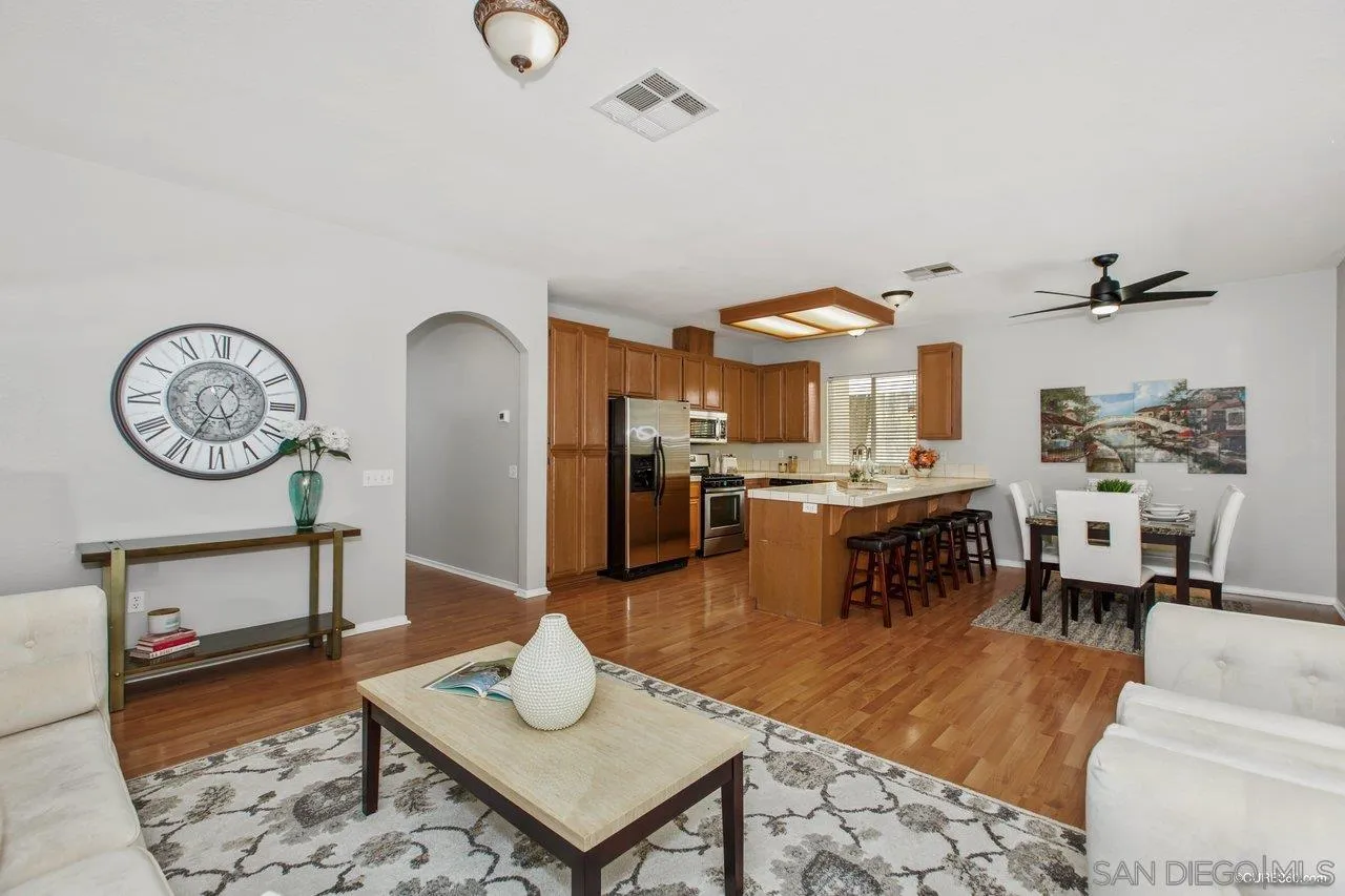 1867 McDougal Terrace El Cajon, CA 92021 - Photo 5 of 28 a living room with kitchen island furniture and a chandelier