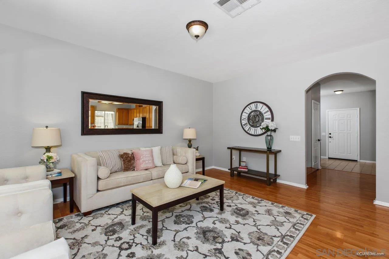 1867 McDougal Terrace El Cajon, CA 92021 - Photo 6 of 28 a living room with furniture a rug and a table