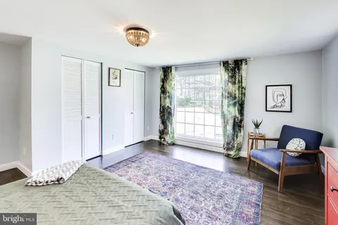 a bedroom with furniture and a window