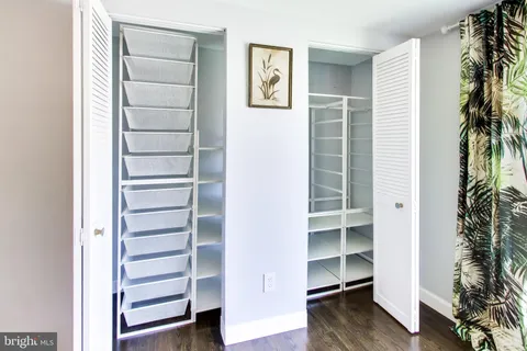 a view of walk in closet with empty racks