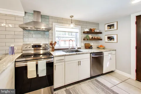 a kitchen with stainless steel appliances granite countertop a stove and a sink