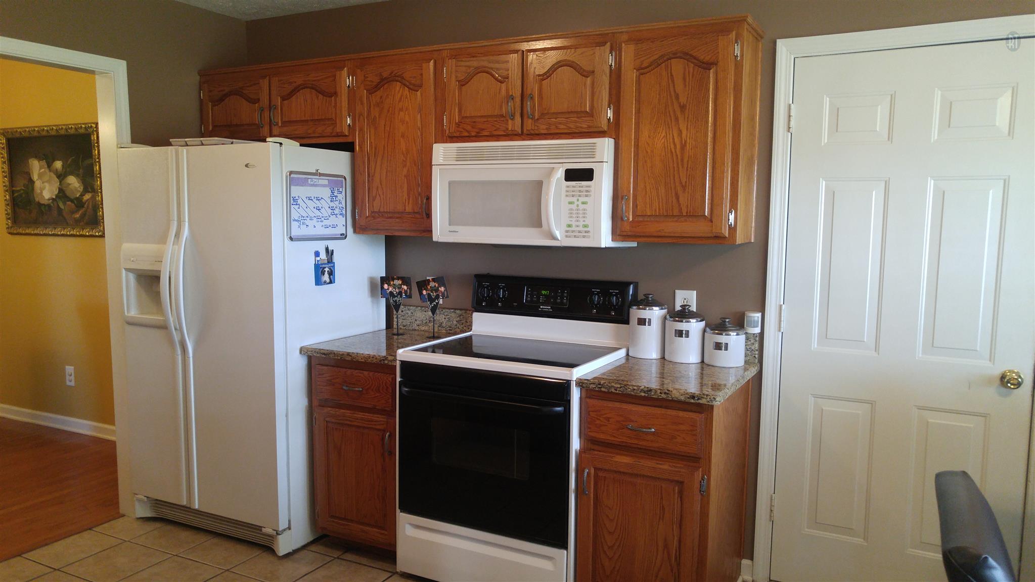 282 Collins Road Portland, TN 37148 - Photo 9 of 28 a kitchen with a refrigerator sink and cabinets