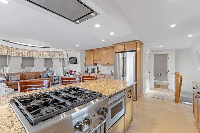 a kitchen with stainless steel appliances granite countertop a stove and a refrigerator