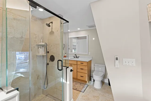 a spacious bathroom with a shower sink and mirror