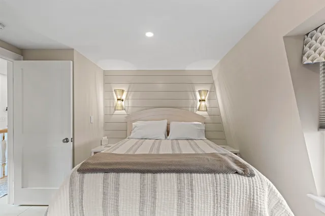 a bedroom with a large bed and a window