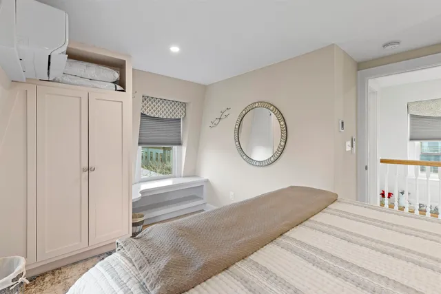 a bedroom with a bed and a mirror