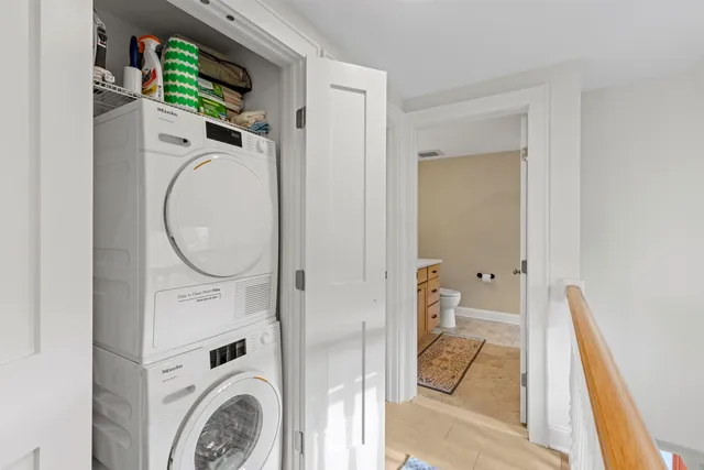 a view of a bedroom with washer and dryer