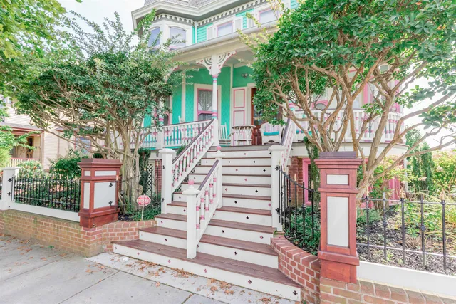 a front view of a house with a yard and plants
