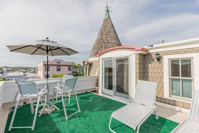 a view of a house with a yard patio and furniture