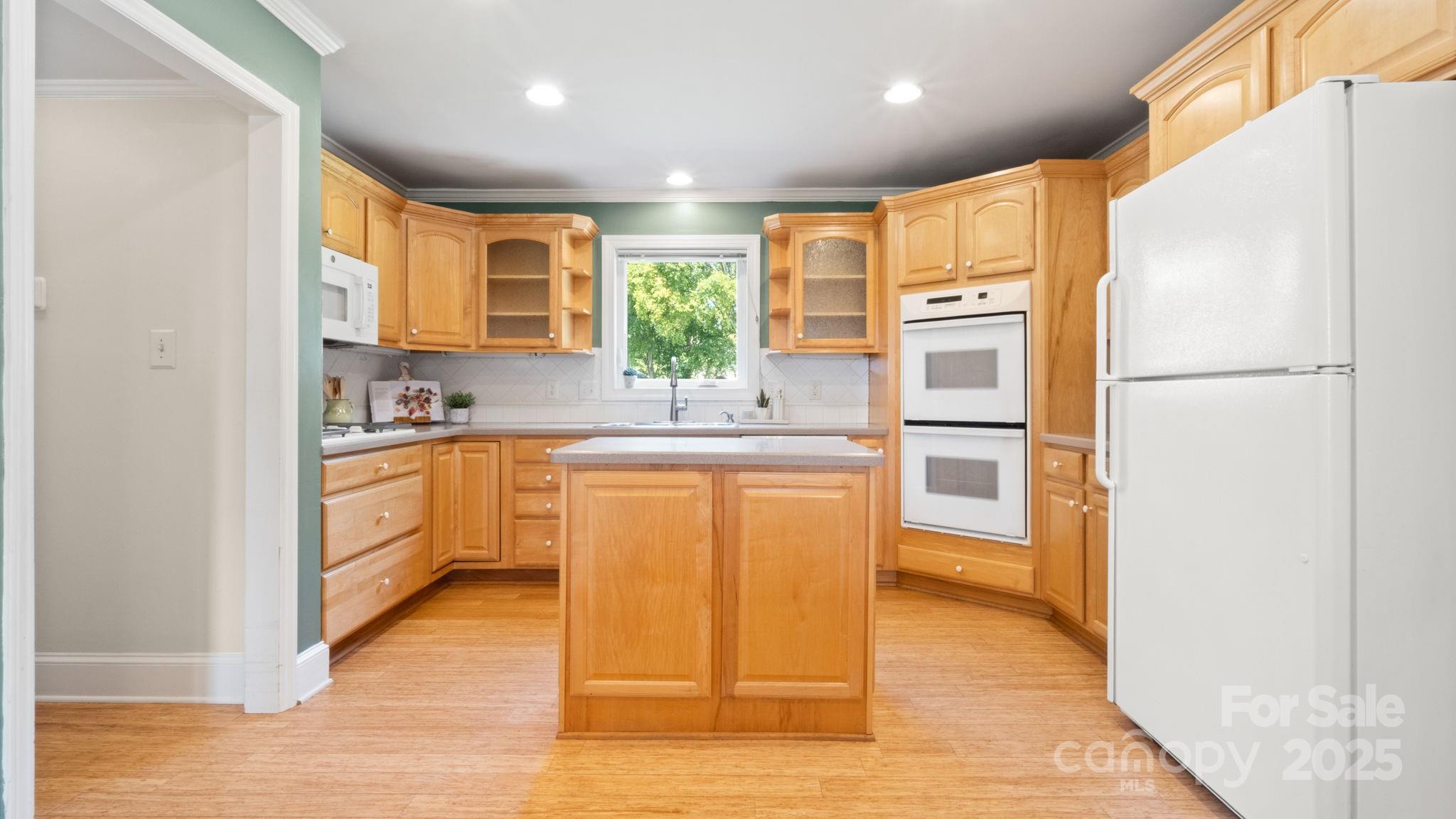 8809 Fairview Road Mint Hill, NC 28227 - Photo 12 of 43 a kitchen with stainless steel appliances granite countertop a refrigerator a sink dishwasher and a stove with wooden floor