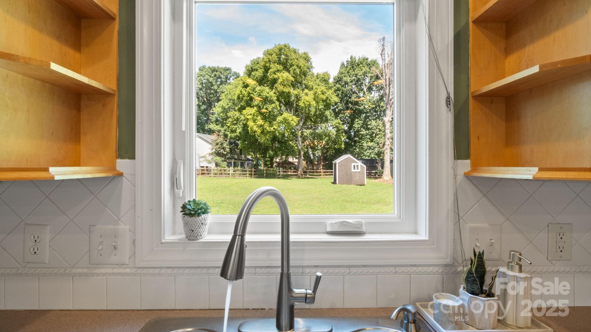 8809 Fairview Road Mint Hill, NC 28227 - Photo 13 of 43 a view of a bathroom with a sink and a window