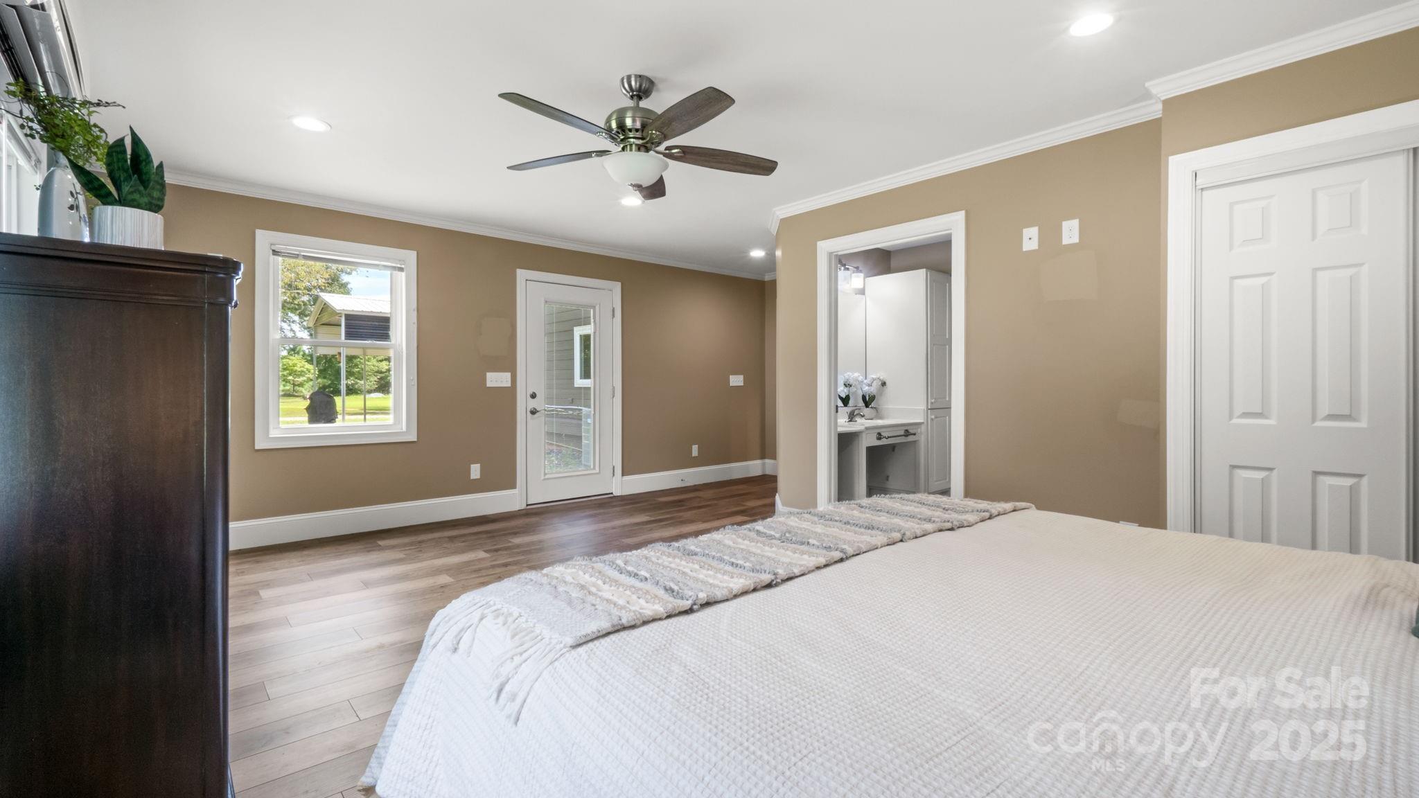 8809 Fairview Road Mint Hill, NC 28227 - Photo 21 of 43 a spacious bedroom with a large bed and chandelier