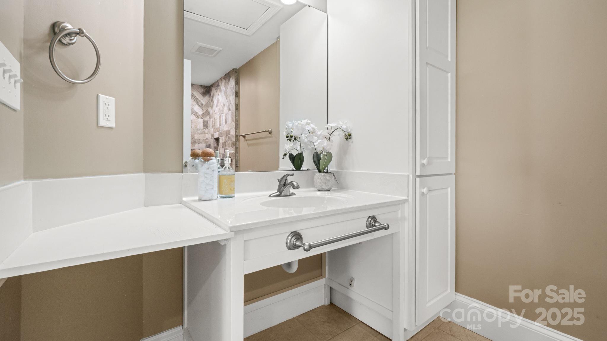 8809 Fairview Road Mint Hill, NC 28227 - Photo 22 of 43 a bathroom with a sink vanity and a mirror