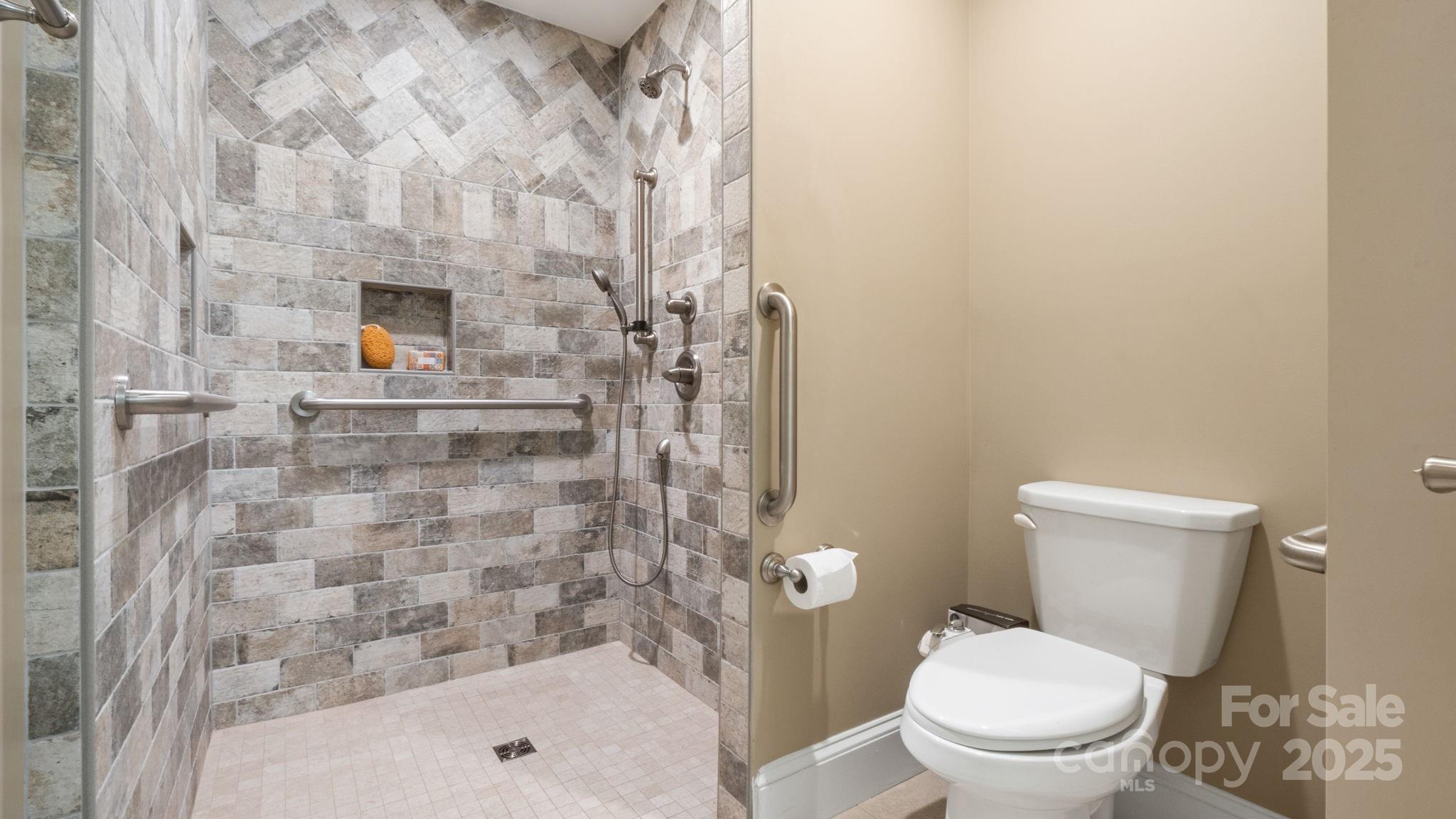 8809 Fairview Road Mint Hill, NC 28227 - Photo 23 of 43 a bathroom with a toilet and a shower
