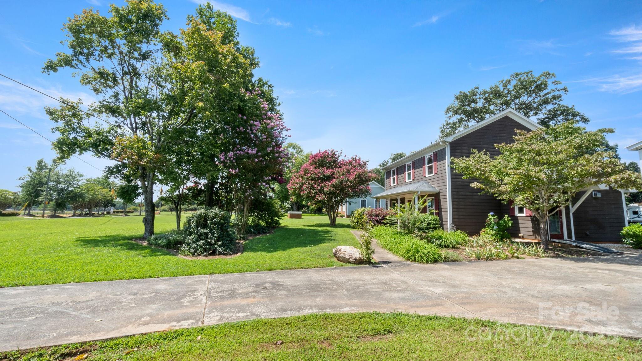 8809 Fairview Road Mint Hill, NC 28227 - Photo 33 of 43 a view of a house with a yard